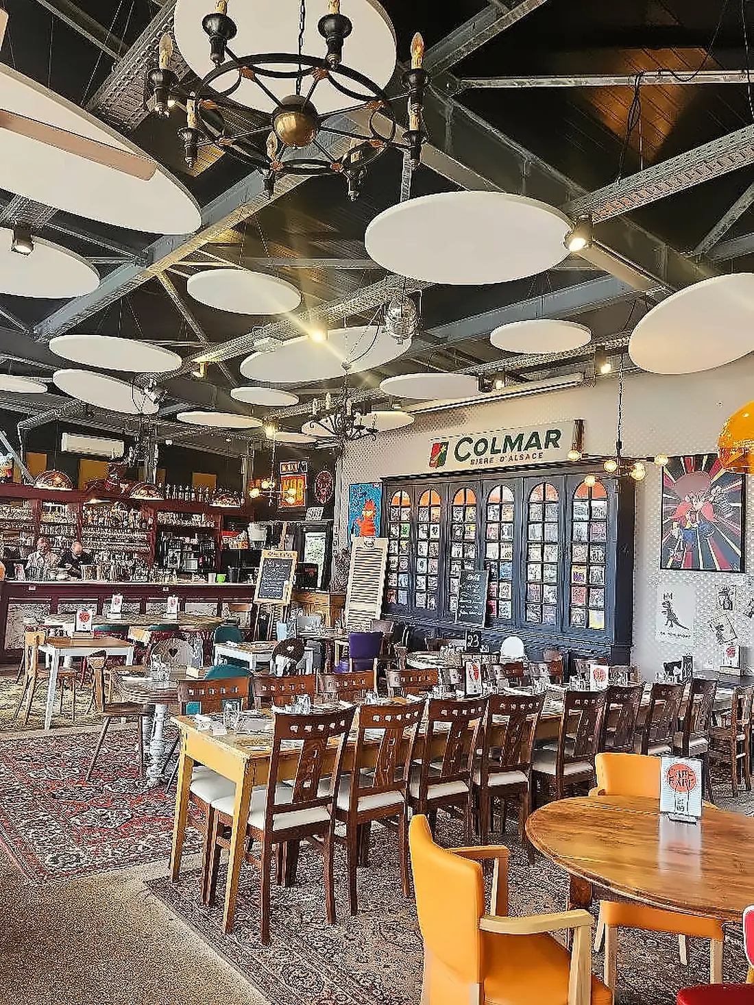 Intérieur du Restaurant Café Rapp : bar, longues tables et déco vintage